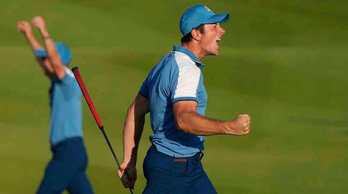 Europe's Viktor Hovland reacts and celebrates after his birdie putt earned Europe a tie in his afternoon fourballs match at the 2023 Ryder Cup in Italy.